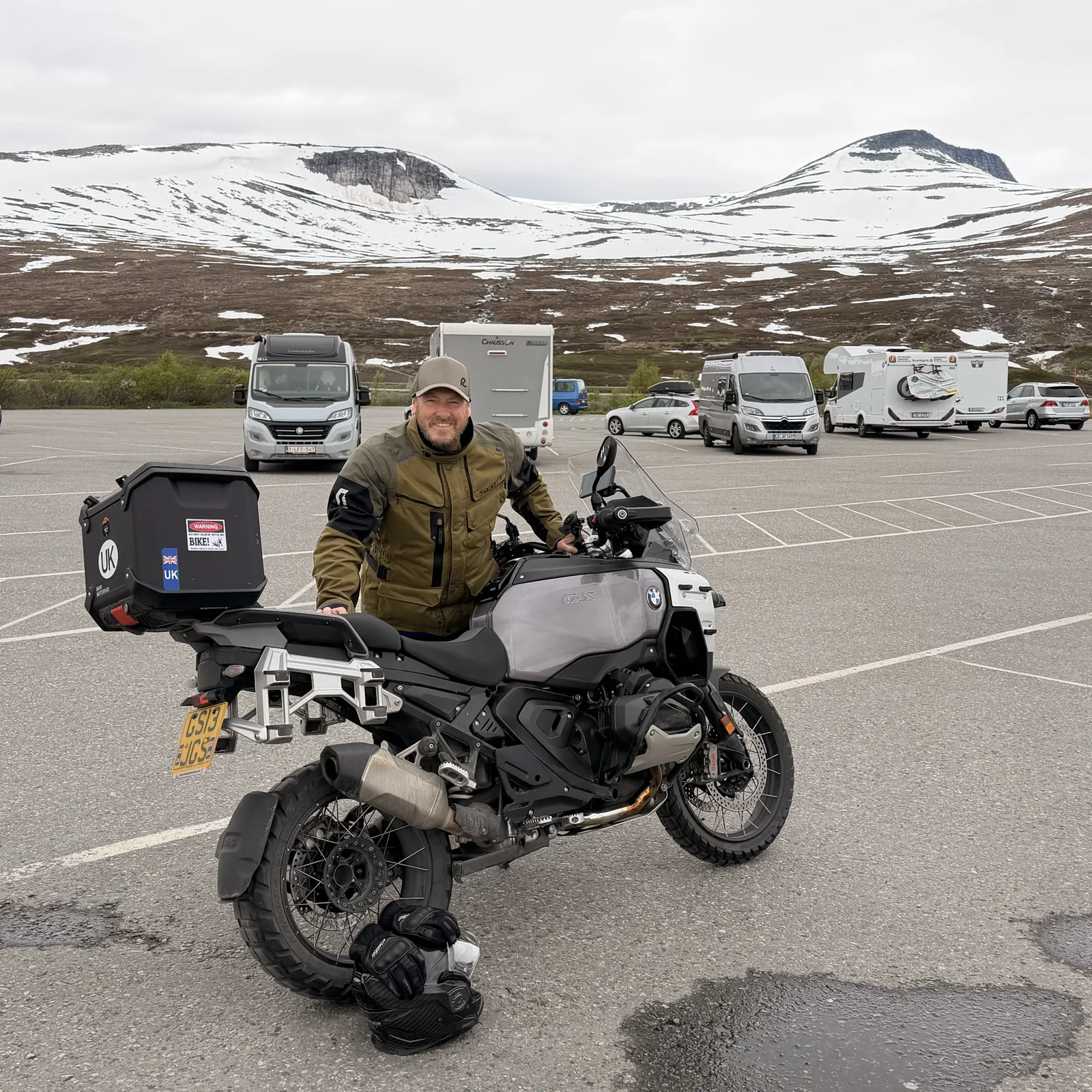 James and his bike at a snowy mountain pass