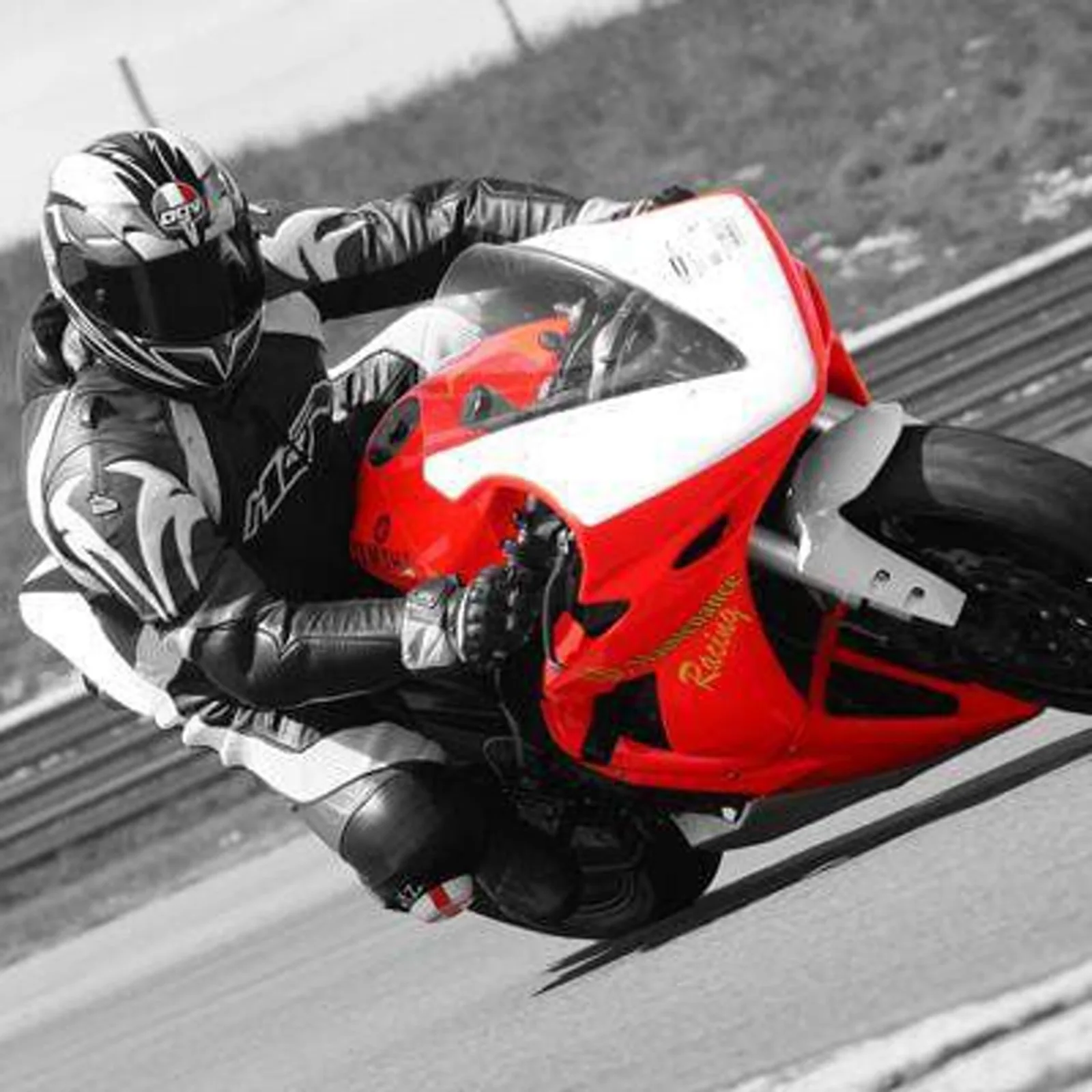 James on a red Yamaha motorcycle on track